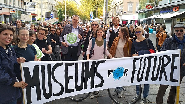  Group of people at a demonstration for the environment carrying a banner that says "Museums for Future"