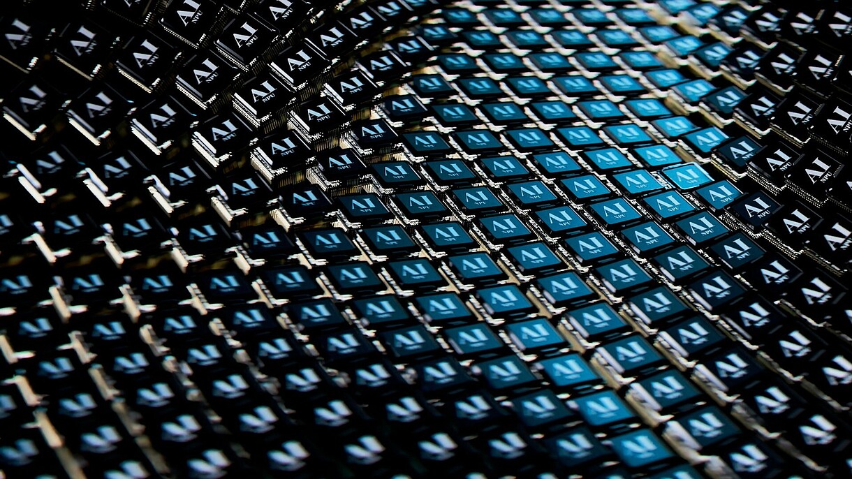 © Image: Igor Omilaev on Unsplash © Image: Igor Omilaev on Unsplash Digital art of a close up view of a blue and black pattern of little squares that all say AI.