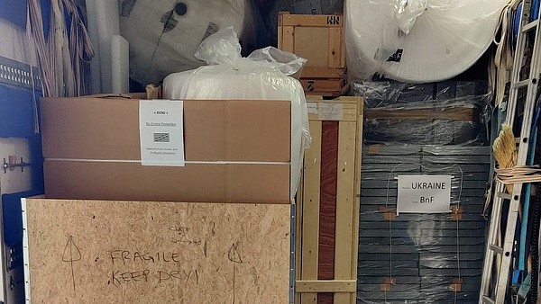This photograph shows the inside of a delivery truck. The flap is open. Inside are multiple boxes.