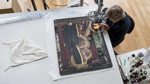  Bird perspective of someone doing restoration work on an icon painting. 