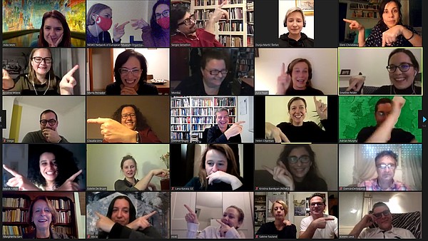 Screenshot of a zoom meeting. The people are all pointing towards each other.