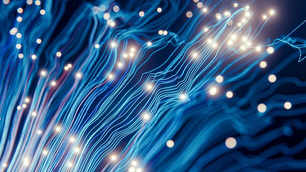  Digital art with abstract blue squiggly lines going from bottom left to top right corner, with white dots scattered.