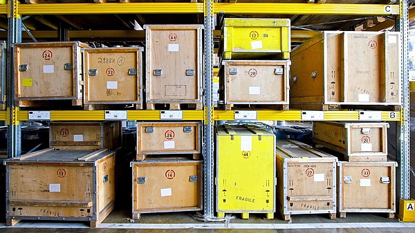 Wooden boxes are large shelves inside a depot.